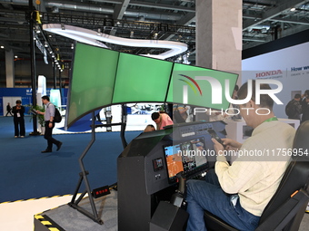 Visitors visit the Honda booth at the ''Future Low Altitude Travel'' area of the Automobile Pavilion at the 7th China International Import E...