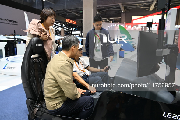 Visitors visit the Honda booth at the ''Future Low Altitude Travel'' area of the Automobile Pavilion at the 7th China International Import E...