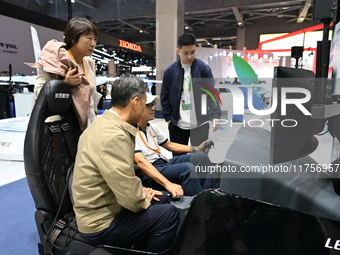 Visitors visit the Honda booth at the ''Future Low Altitude Travel'' area of the Automobile Pavilion at the 7th China International Import E...