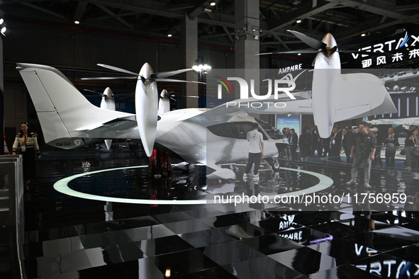 Visitors visit the vertaxi booth in the ''Future Low Altitude Travel'' area of the Automobile Pavilion at the 7th China International Import...