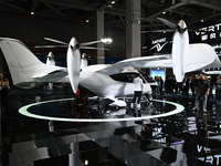 Visitors visit the vertaxi booth in the ''Future Low Altitude Travel'' area of the Automobile Pavilion at the 7th China International Import...