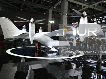 Visitors visit the vertaxi booth in the ''Future Low Altitude Travel'' area of the Automobile Pavilion at the 7th China International Import...