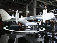 Visitors visit the vertaxi booth in the ''Future Low Altitude Travel'' area of the Automobile Pavilion at the 7th China International Import...