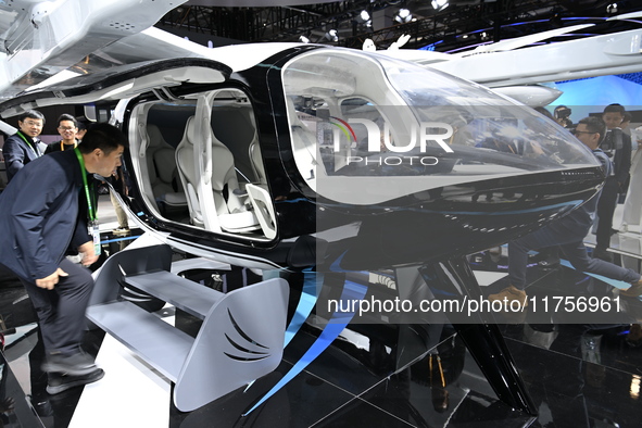 Visitors visit the vertaxi booth in the ''Future Low Altitude Travel'' area of the Automobile Pavilion at the 7th China International Import...