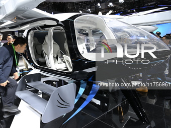 Visitors visit the vertaxi booth in the ''Future Low Altitude Travel'' area of the Automobile Pavilion at the 7th China International Import...