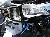 Visitors visit the vertaxi booth in the ''Future Low Altitude Travel'' area of the Automobile Pavilion at the 7th China International Import...