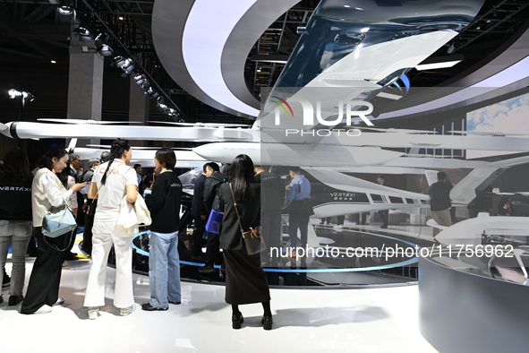 Visitors visit the vertaxi booth in the ''Future Low Altitude Travel'' area of the Automobile Pavilion at the 7th China International Import...