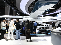 Visitors visit the vertaxi booth in the ''Future Low Altitude Travel'' area of the Automobile Pavilion at the 7th China International Import...