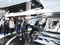 Visitors visit the vertaxi booth in the ''Future Low Altitude Travel'' area of the Automobile Pavilion at the 7th China International Import...