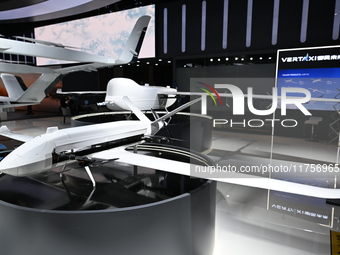 Visitors visit the vertaxi booth in the ''Future Low Altitude Travel'' area of the Automobile Pavilion at the 7th China International Import...