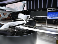 Visitors visit the vertaxi booth in the ''Future Low Altitude Travel'' area of the Automobile Pavilion at the 7th China International Import...