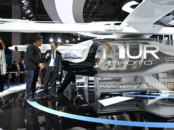 Visitors visit the vertaxi booth in the ''Future Low Altitude Travel'' area of the Automobile Pavilion at the 7th China International Import...