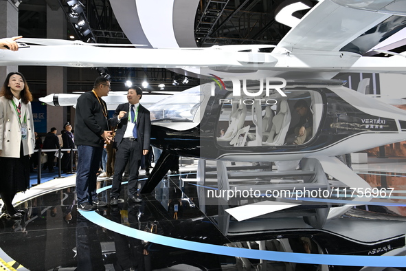 Visitors visit the vertaxi booth in the ''Future Low Altitude Travel'' area of the Automobile Pavilion at the 7th China International Import...