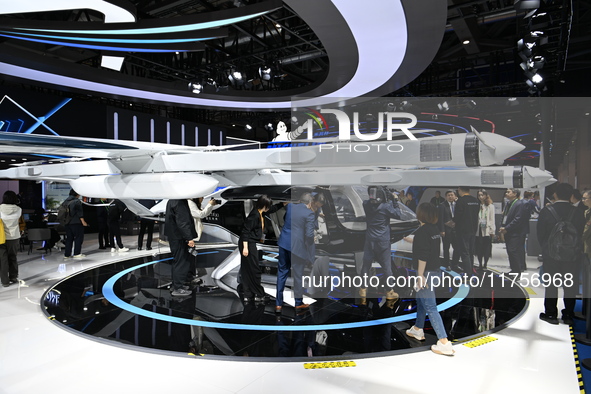 Visitors visit the vertaxi booth in the ''Future Low Altitude Travel'' area of the Automobile Pavilion at the 7th China International Import...