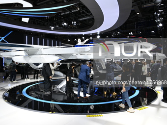 Visitors visit the vertaxi booth in the ''Future Low Altitude Travel'' area of the Automobile Pavilion at the 7th China International Import...