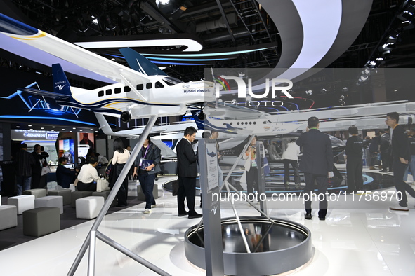 Visitors visit the vertaxi booth in the ''Future Low Altitude Travel'' area of the Automobile Pavilion at the 7th China International Import...