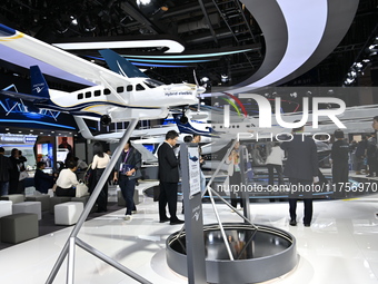 Visitors visit the vertaxi booth in the ''Future Low Altitude Travel'' area of the Automobile Pavilion at the 7th China International Import...