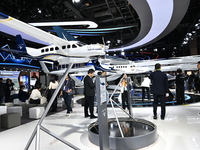 Visitors visit the vertaxi booth in the ''Future Low Altitude Travel'' area of the Automobile Pavilion at the 7th China International Import...