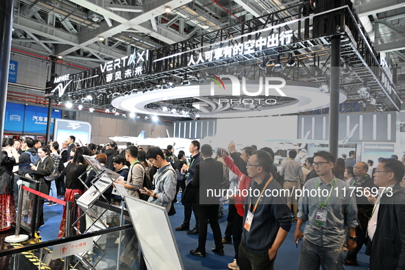 Visitors visit the vertaxi booth in the ''Future Low Altitude Travel'' area of the Automobile Pavilion at the 7th China International Import...