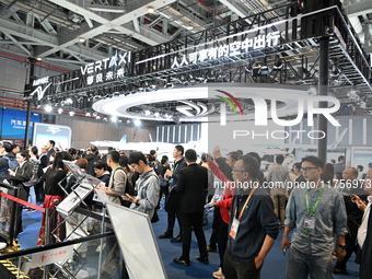 Visitors visit the vertaxi booth in the ''Future Low Altitude Travel'' area of the Automobile Pavilion at the 7th China International Import...