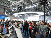 Visitors visit the vertaxi booth in the ''Future Low Altitude Travel'' area of the Automobile Pavilion at the 7th China International Import...