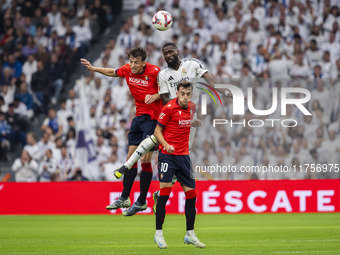 Antonio Rudiger of Real Madrid CF (center) heads the ball between Ante Budimir (left) and Aimar Oroz (right) of CA Osasuna during the La Lig...