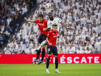 Antonio Rudiger of Real Madrid CF (center) heads the ball between Ante Budimir (left) and Aimar Oroz (right) of CA Osasuna during the La Lig...