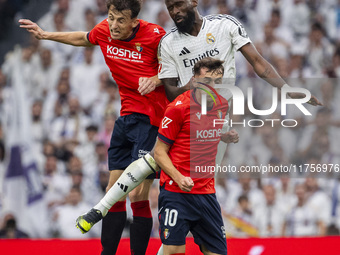 Antonio Rudiger of Real Madrid CF (center) heads the ball between Ante Budimir (left) and Aimar Oroz (right) of CA Osasuna during the La Lig...