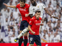 Antonio Rudiger of Real Madrid CF (center) heads the ball between Ante Budimir (left) and Aimar Oroz (right) of CA Osasuna during the La Lig...