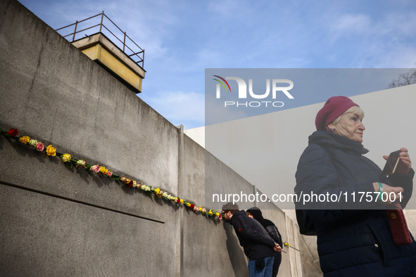 Flowers at Berlin Wall Memorial after the commemoration ceremony marking the 35th anniversary of the fall of the Berlin Wall. Berlin, German...