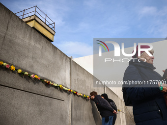 Flowers at Berlin Wall Memorial after the commemoration ceremony marking the 35th anniversary of the fall of the Berlin Wall. Berlin, German...