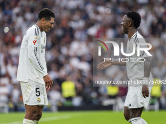 Vinicius Junior of Real Madrid CF (R) celebrates his goal with Jude Bellingham of Real Madrid CF (L) during the La Liga EA Sports 2024/25 fo...