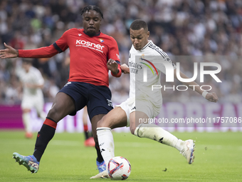 Kylian Mbappe of Real Madrid attempts a shot during the La Liga 2024/25 match between Real Madrid and Osasuna at Santiago Bernabeu Stadium i...