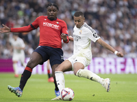 Kylian Mbappe of Real Madrid attempts a shot during the La Liga 2024/25 match between Real Madrid and Osasuna at Santiago Bernabeu Stadium i...