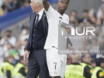 Vinicius Jr of Real Madrid greets fans during the La Liga 2024/25 match between Real Madrid and Osasuna at Santiago Bernabeu Stadium in Madr...