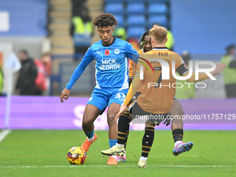 James Donnelly (33 Peterborough United) is challenged by James Brophy (7 Cambridge United) during the Sky Bet League 1 match between Peterbo...