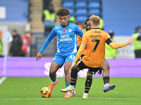 James Donnelly (33 Peterborough United) is challenged by James Brophy (7 Cambridge United) during the Sky Bet League 1 match between Peterbo...