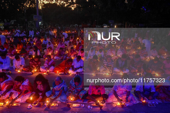 Devotees offer prayers by lighting oil lamps and incense sticks to Sri Loknath Brahmachari on the occasion of Karthik Brata at a Loknath Bra...