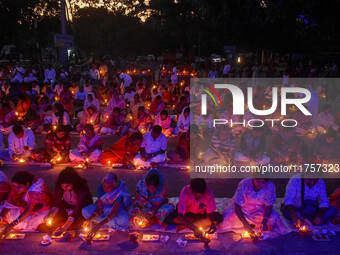 Devotees offer prayers by lighting oil lamps and incense sticks to Sri Loknath Brahmachari on the occasion of Karthik Brata at a Loknath Bra...