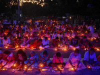 Devotees offer prayers by lighting oil lamps and incense sticks to Sri Loknath Brahmachari on the occasion of Karthik Brata at a Loknath Bra...