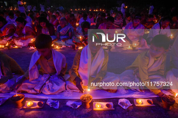 Devotees offer prayers by lighting oil lamps and incense sticks to Sri Loknath Brahmachari on the occasion of Karthik Brata at a Loknath Bra...