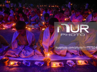 Devotees offer prayers by lighting oil lamps and incense sticks to Sri Loknath Brahmachari on the occasion of Karthik Brata at a Loknath Bra...