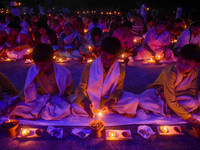 Devotees offer prayers by lighting oil lamps and incense sticks to Sri Loknath Brahmachari on the occasion of Karthik Brata at a Loknath Bra...