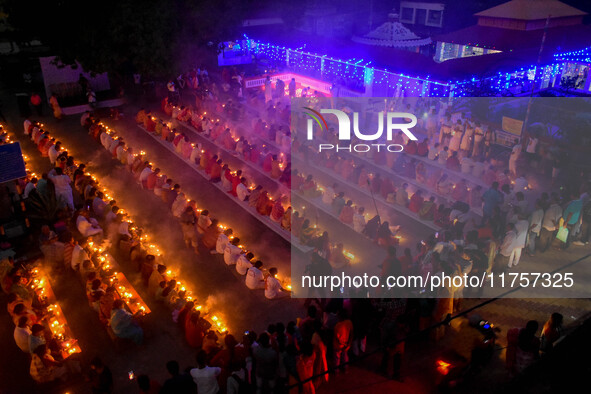 Devotees offer prayers by lighting oil lamps and incense sticks to Sri Loknath Brahmachari on the occasion of Karthik Brata at a Loknath Bra...