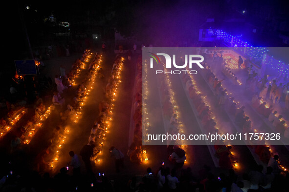 Devotees offer prayers by lighting oil lamps and incense sticks to Sri Loknath Brahmachari on the occasion of Karthik Brata at a Loknath Bra...