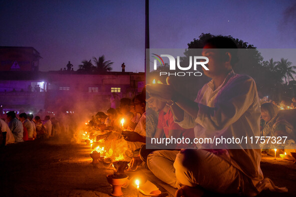 Devotees offer prayers by lighting oil lamps and incense sticks to Sri Loknath Brahmachari on the occasion of Karthik Brata at a Loknath Bra...