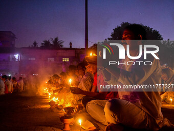 Devotees offer prayers by lighting oil lamps and incense sticks to Sri Loknath Brahmachari on the occasion of Karthik Brata at a Loknath Bra...