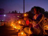 Devotees offer prayers by lighting oil lamps and incense sticks to Sri Loknath Brahmachari on the occasion of Karthik Brata at a Loknath Bra...