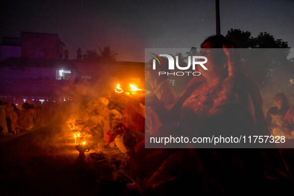 Devotees offer prayers by lighting oil lamps and incense sticks to Sri Loknath Brahmachari on the occasion of Karthik Brata at a Loknath Bra...