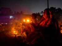 Devotees offer prayers by lighting oil lamps and incense sticks to Sri Loknath Brahmachari on the occasion of Karthik Brata at a Loknath Bra...